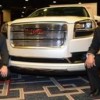 Two Hispanic Faces Behind GMC Trucks